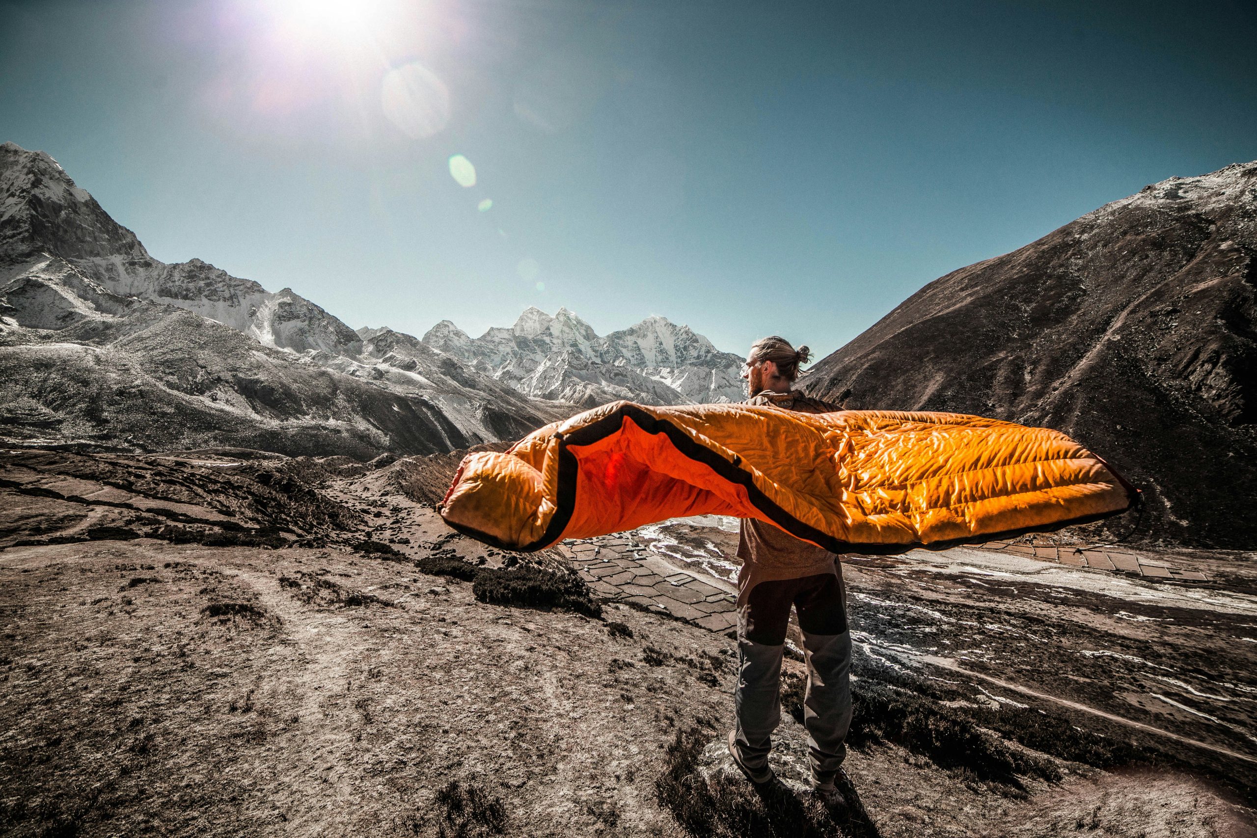 person holding a sleeping bag